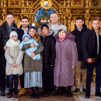 спільне фото на хрестинах на тлі іконостасу