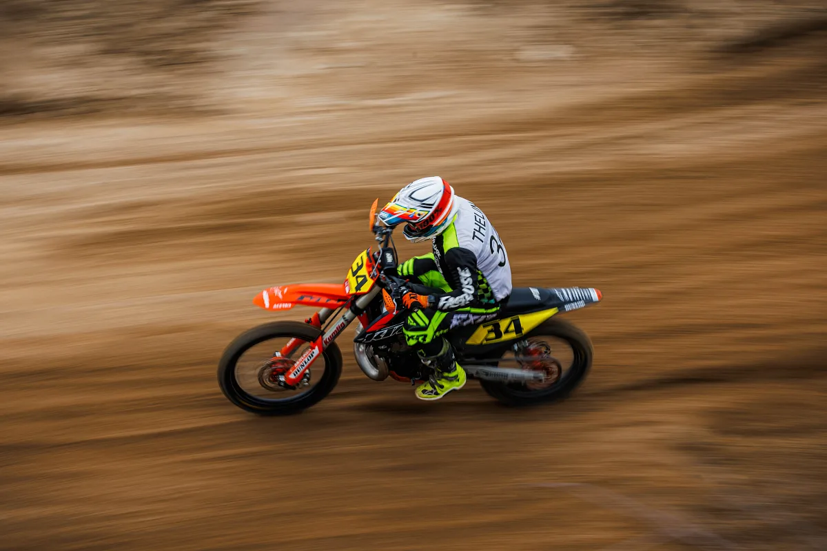 Motocross rider on an orange bike with a panning blur, Alingsås