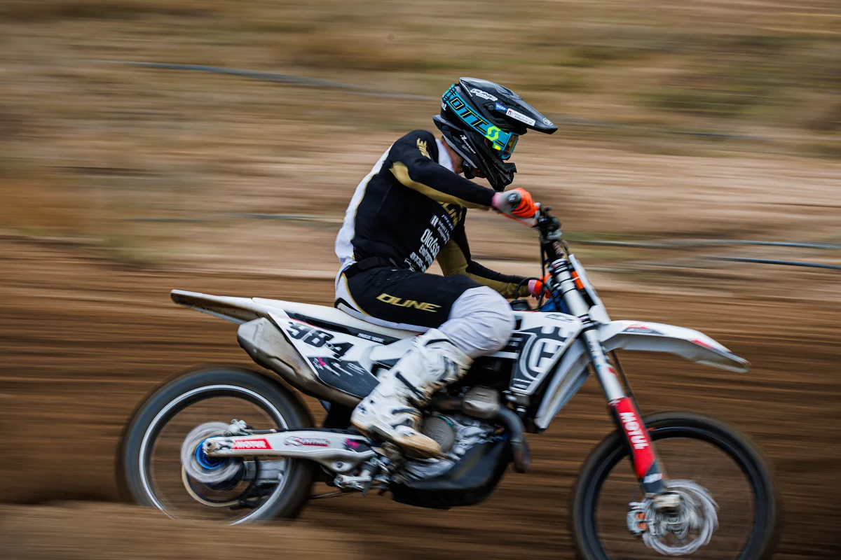 Motocross rider in black and white on a bike with motion blur, Alingsås