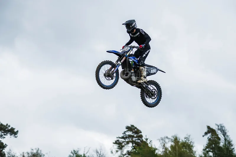 Motocross rider high in the air against a white sky, Varberg